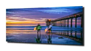 obraz na szkle Rozmazani surferzy na plaży 